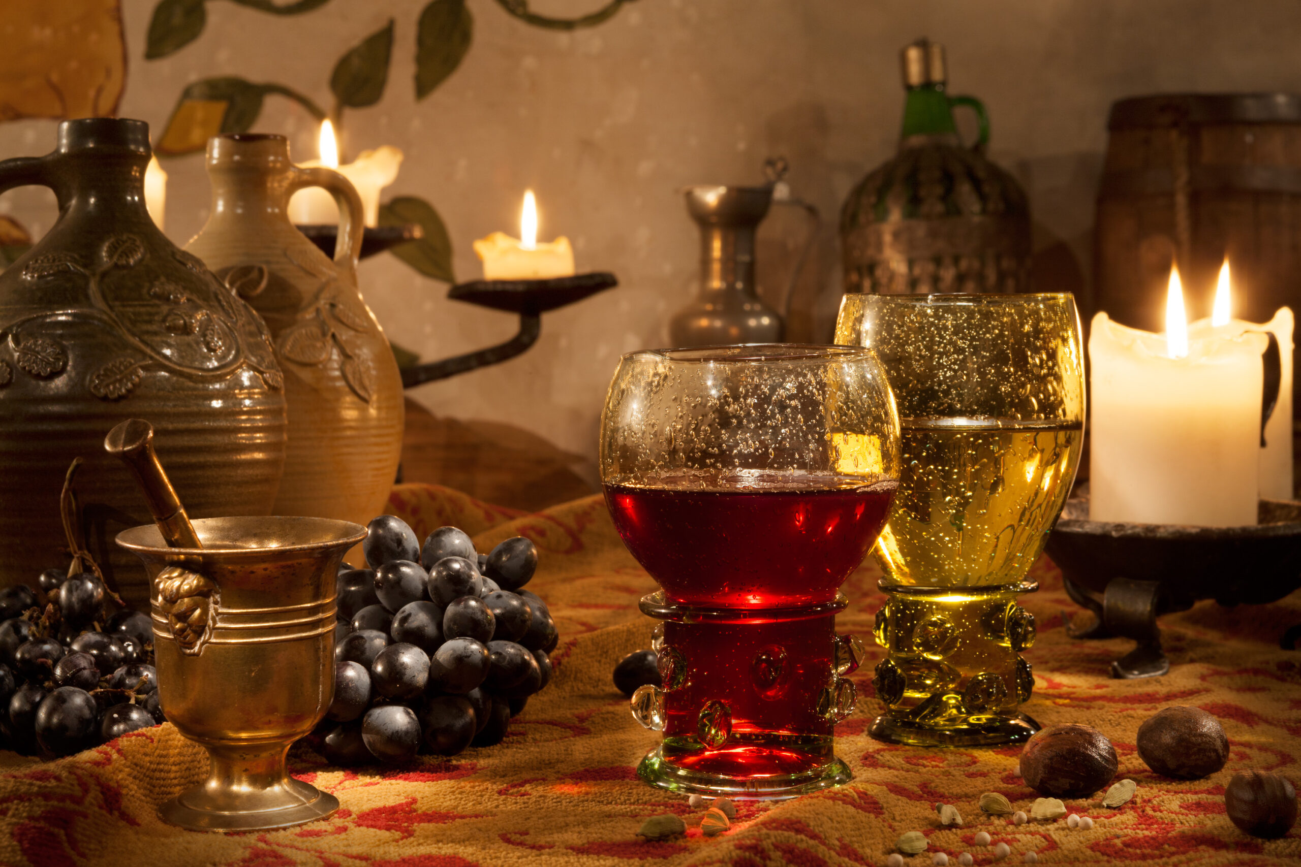 Forest-glass römers of red and white wine by candlelight